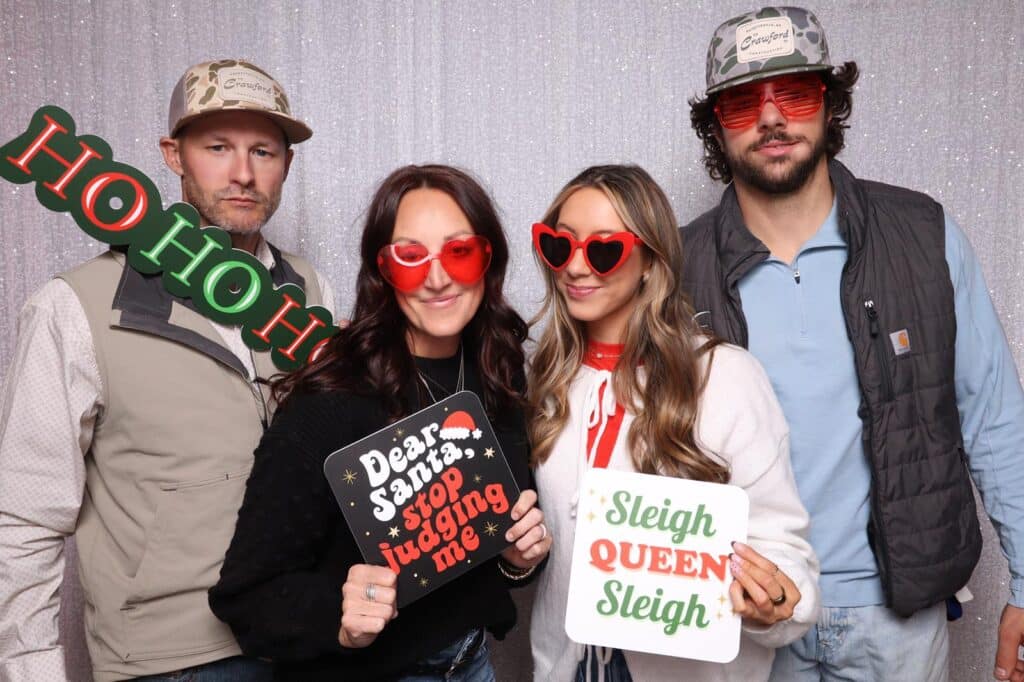 Group of friends holding props and wearing funky sunglasses