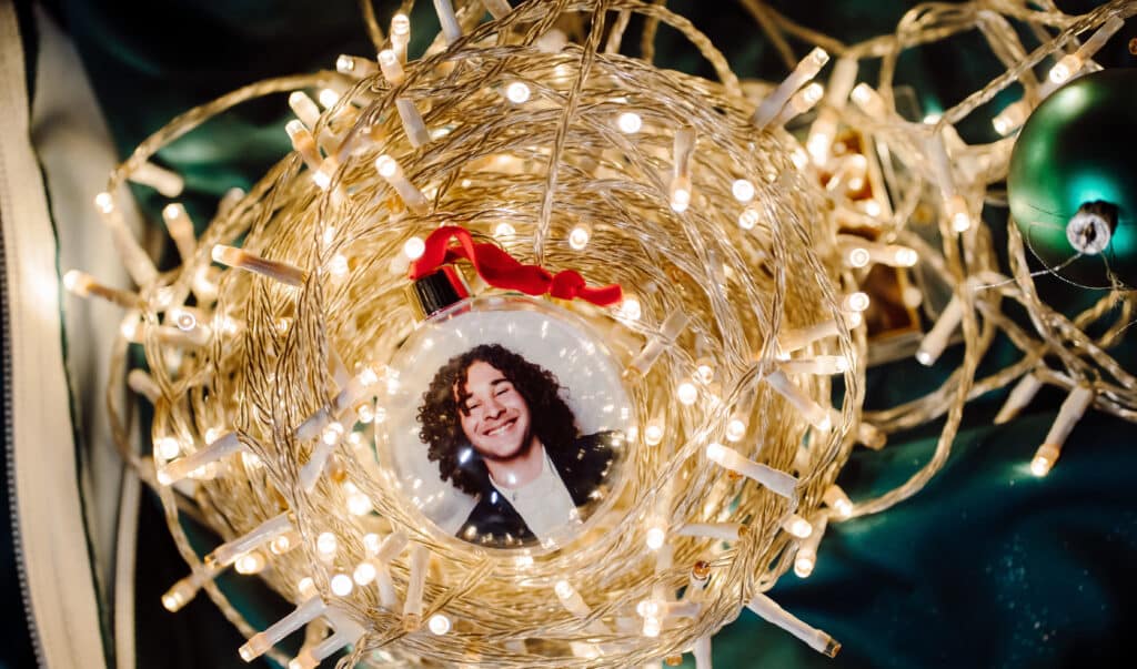 Personalized holiday ornament with photo and string lights, interactive holiday activation for shopping centers.